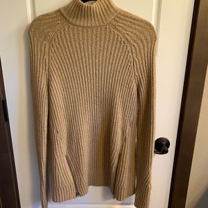 Long turtle neck tan sweater.
